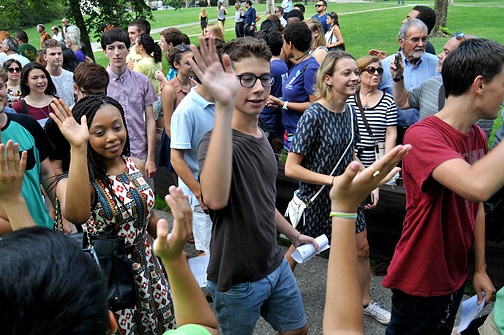 Photo of students walking and high fiving.